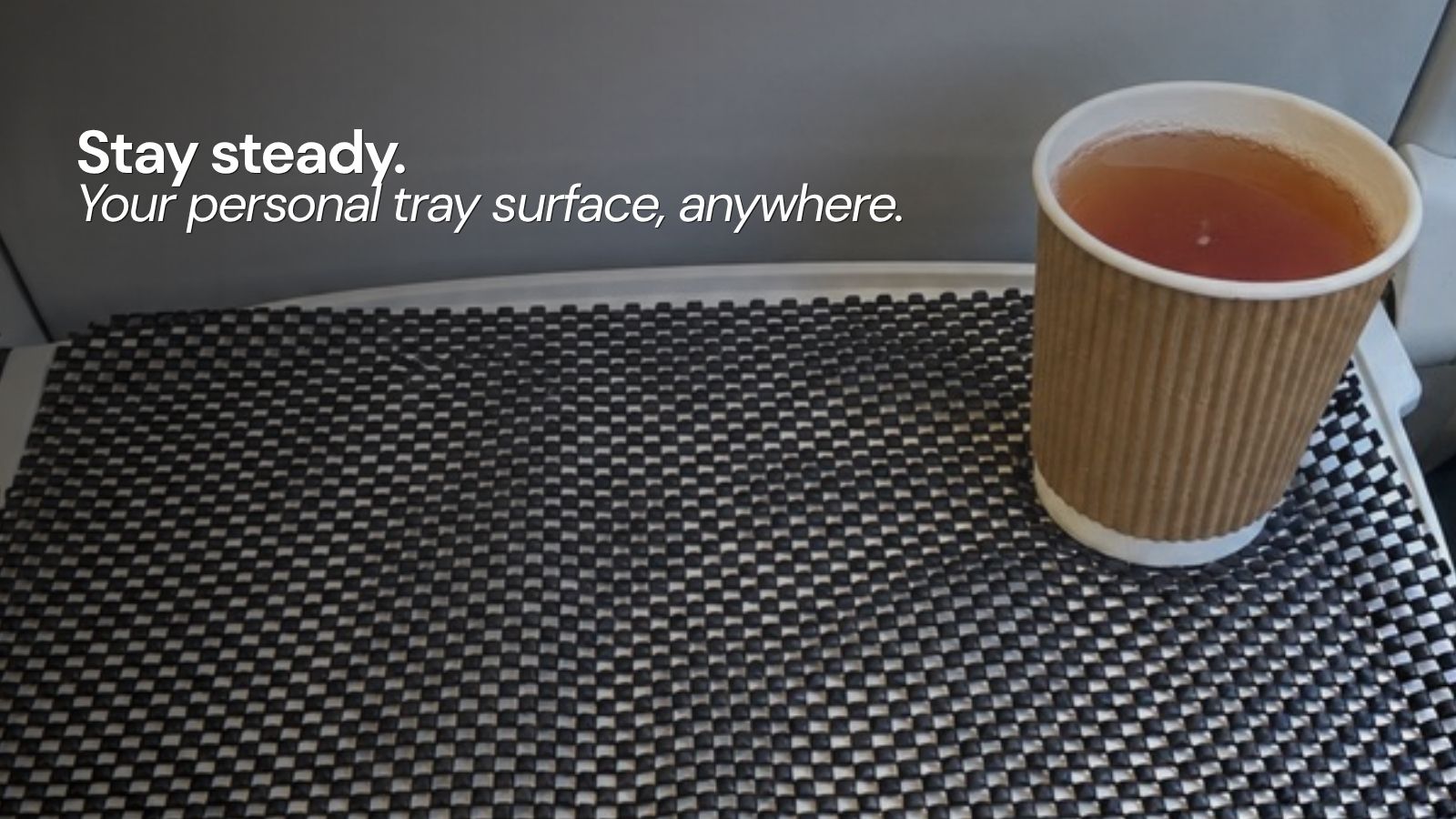TrayMat providing a clean, non-slip surface on a train tray table
